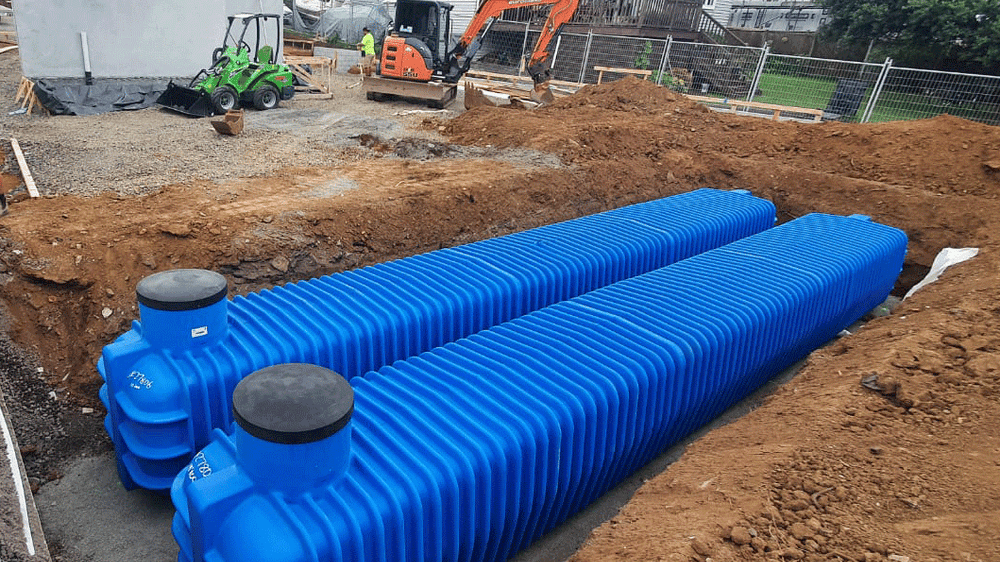 Two Promax underground tanks being installed in a trench on a New Zealand residential build site