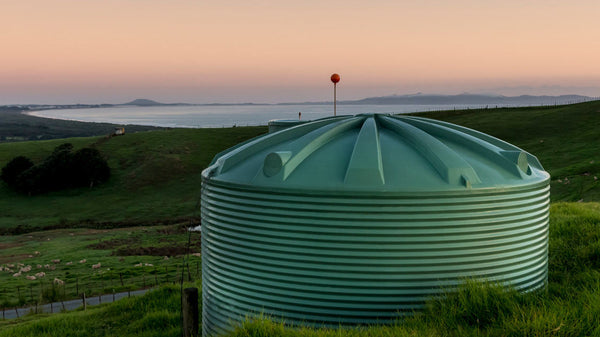 Promax rainwater tank on a New Zealand hill country farm at dawn